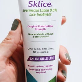 a photo of a person holding a tube of Sklice