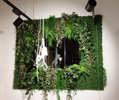 hanging monkey lamp feature wall of greenery
