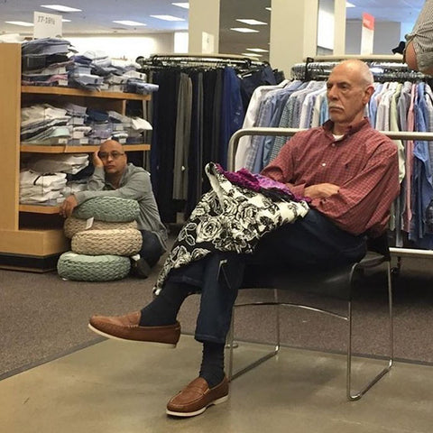 Miserable men sitting and waiting in shopping centres