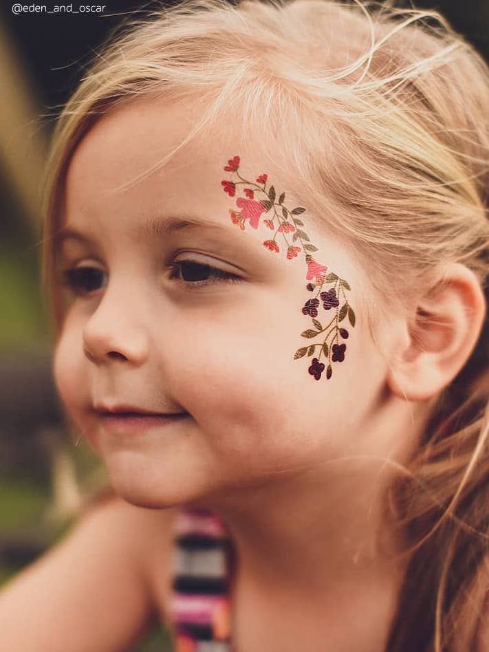 Premium Photo  A tattoo of a flower with a blue eye and flowers on the face 