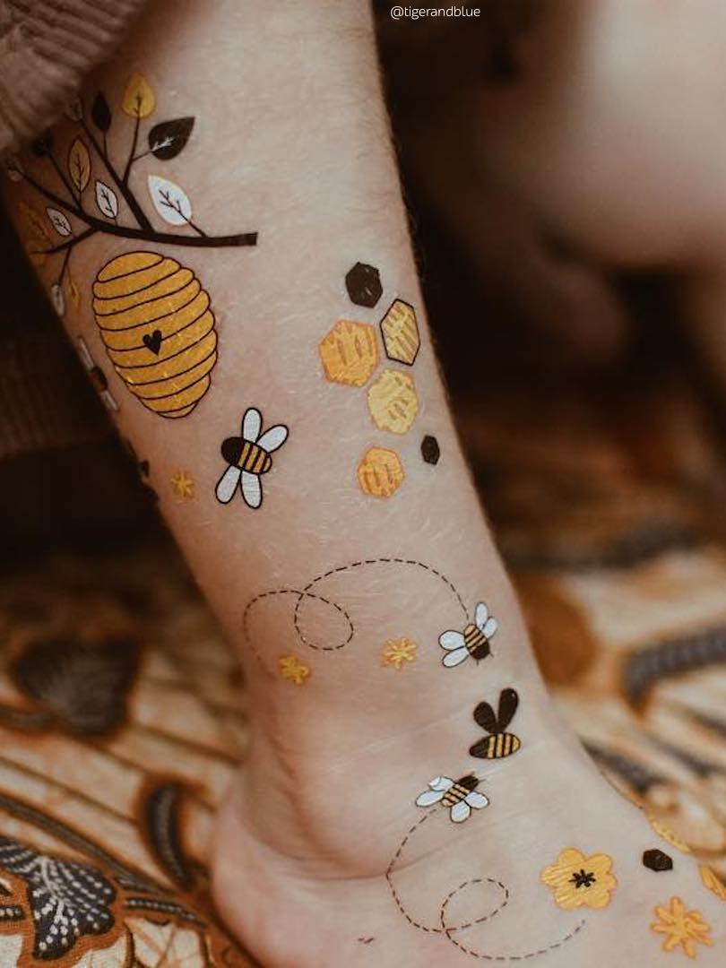 Bee  flowers tattoo on the inner arm