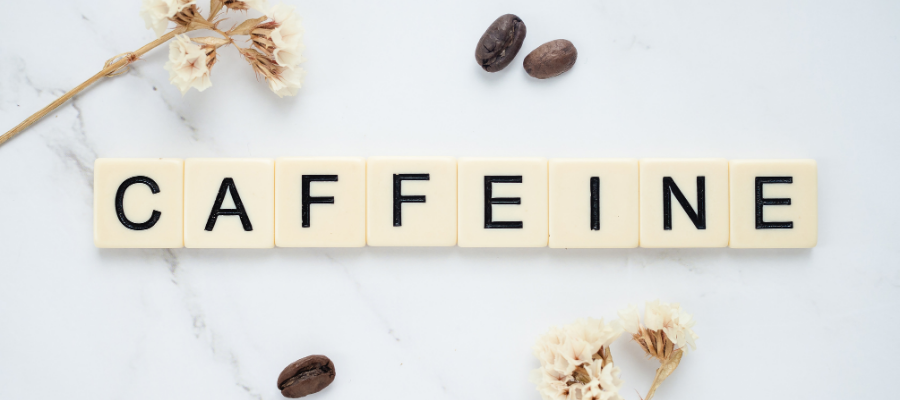 caffeine spelled out using letters on a grey background