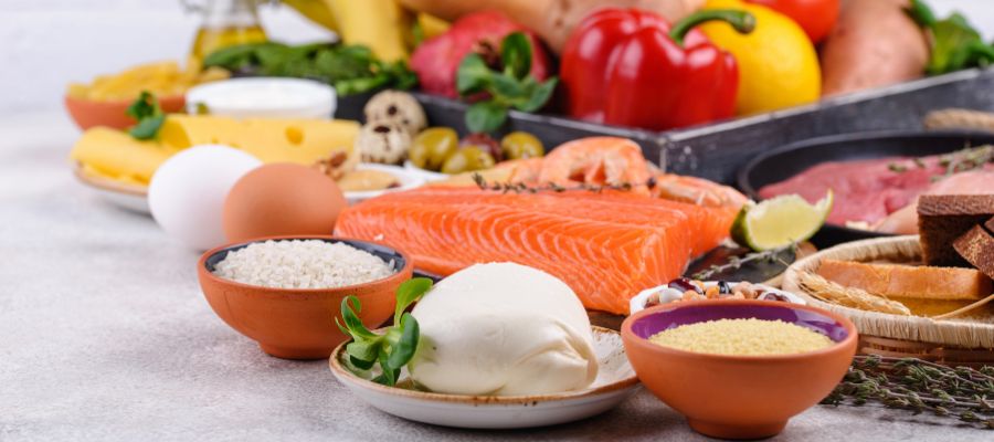 Mediteranean diet, with salmon, eggs, vegetables and a colourful display of a variety of healthy foods