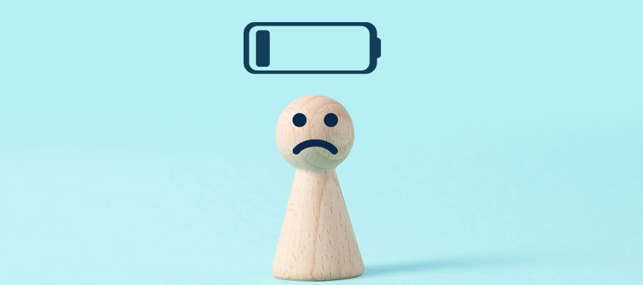 wooden doll with sad face and low battery icon with a blue background