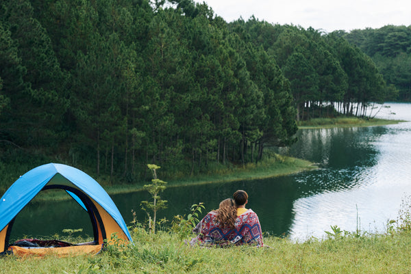a couple camping near the river