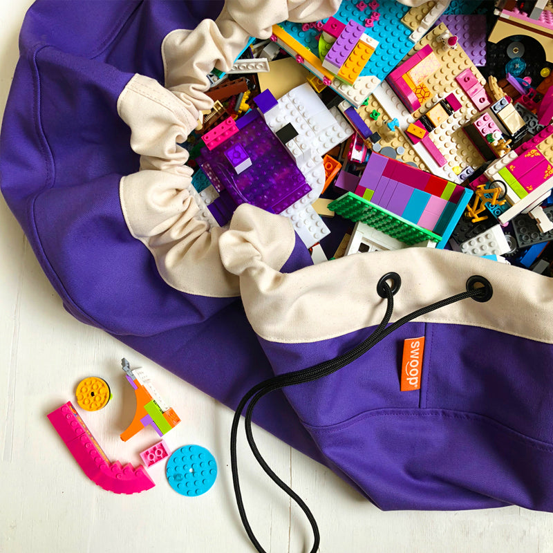 purple grape swoop bag opened with lego bricks