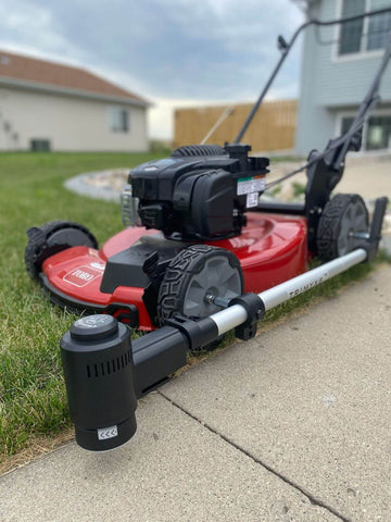 a close-up of the Trimyxs attached to the red push lawn mower