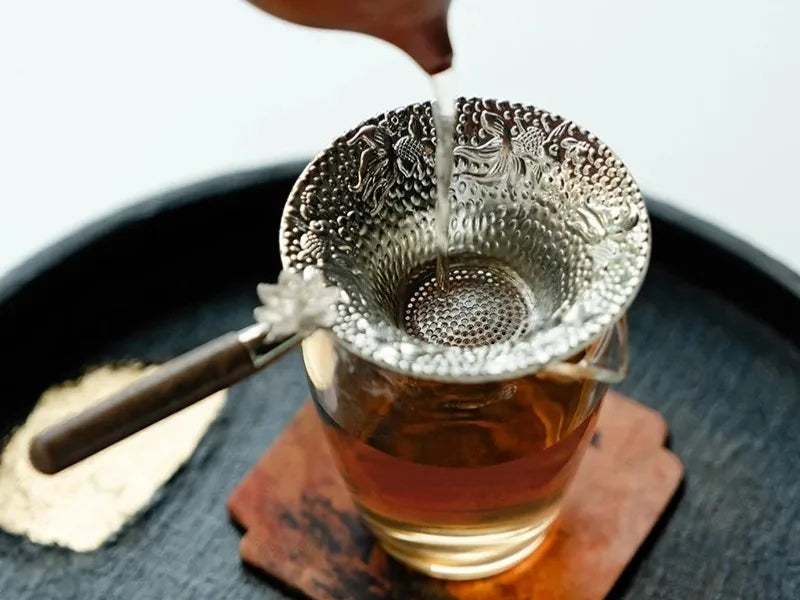Gong Dao Bei with a tea strainer resting on top, ready for brewing