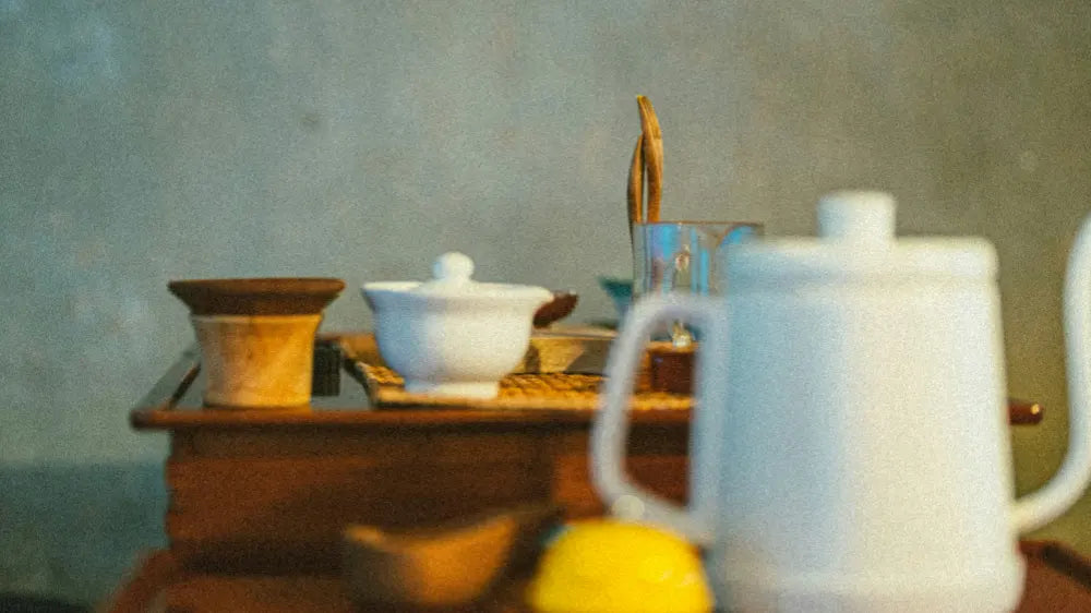 Side view of a tea table with Gongfu tea set arranged on the surface.