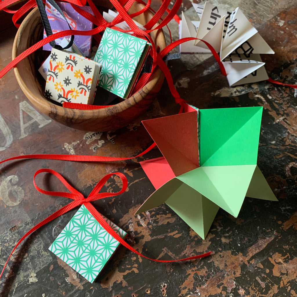Learn how to make an origami star book decoration from coloured and patterned paper.