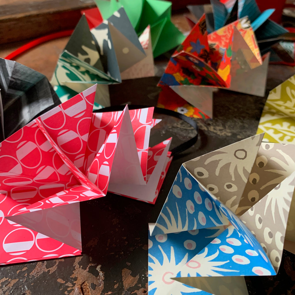 A selection of origami star books made from a variety of patterned papers including Osity and Cambridge Imprint.