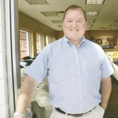 Randy Pegan standing at the door of the mattress showroom.