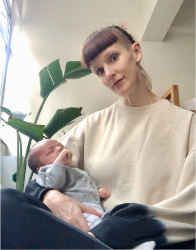 Levi's 501 Girl Project : Woman styled in sweater and holding baby in her arms - Levi's Hong Kong