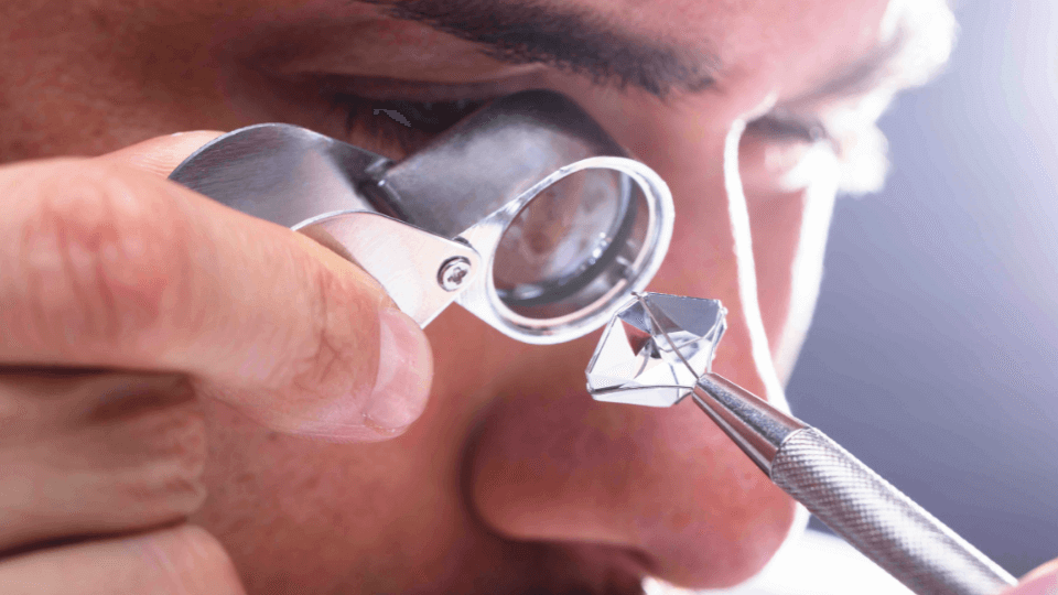 A diamond appraiser reviewing and evaluating the quality of a diamond