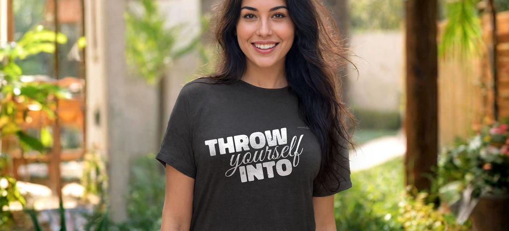 Happy smiling girl with a t-shirt with "Throw yourself Into" written on it