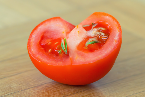 Red tomato cut in half with seeds