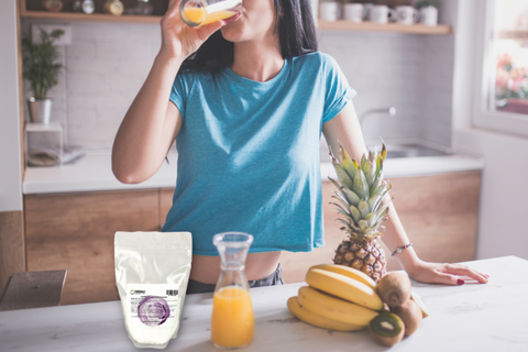 Woman drinking magnesium chloride supplement in orange juice