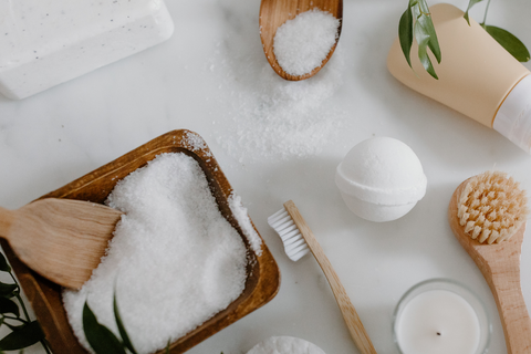 Wooden bowl of Epsom Salt with an Epsom Salt bath bomb