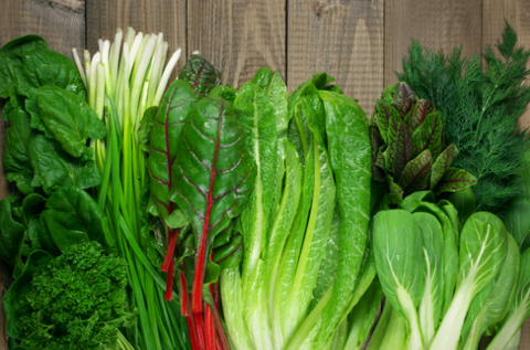 Leafy greens on wooden table