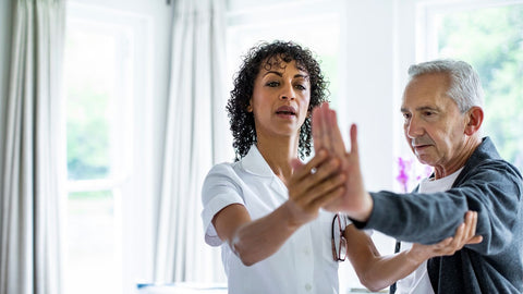 older man with osteoarthritis working with physical therapist