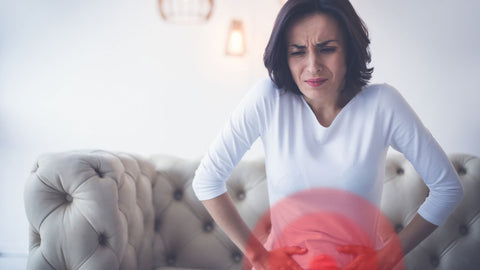woman with endometriosis pain holding pelvis