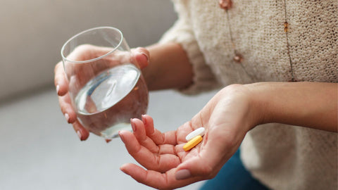 woman drinking magnesium pills