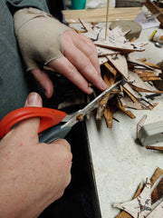 shaping the cork triangles by cutting them to create the tree