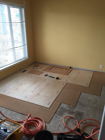 Multipurpose room after removing old carpets and starting the install of quiet cork and new subfloor.