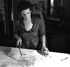 Black and white photo Christine Sajecki working in her studio