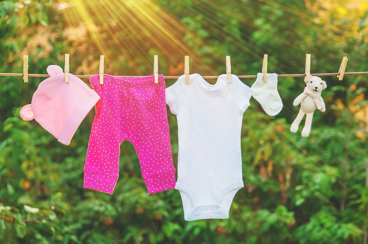 Baby girl clothes hanging on a line