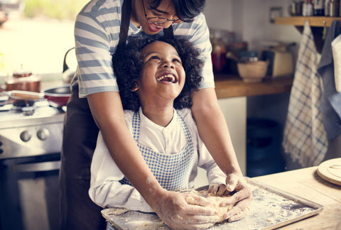 mom and child baking pretzels from scratch