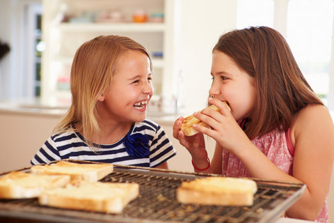 two girls eating grilled cheese - memorial day indoor grilling
