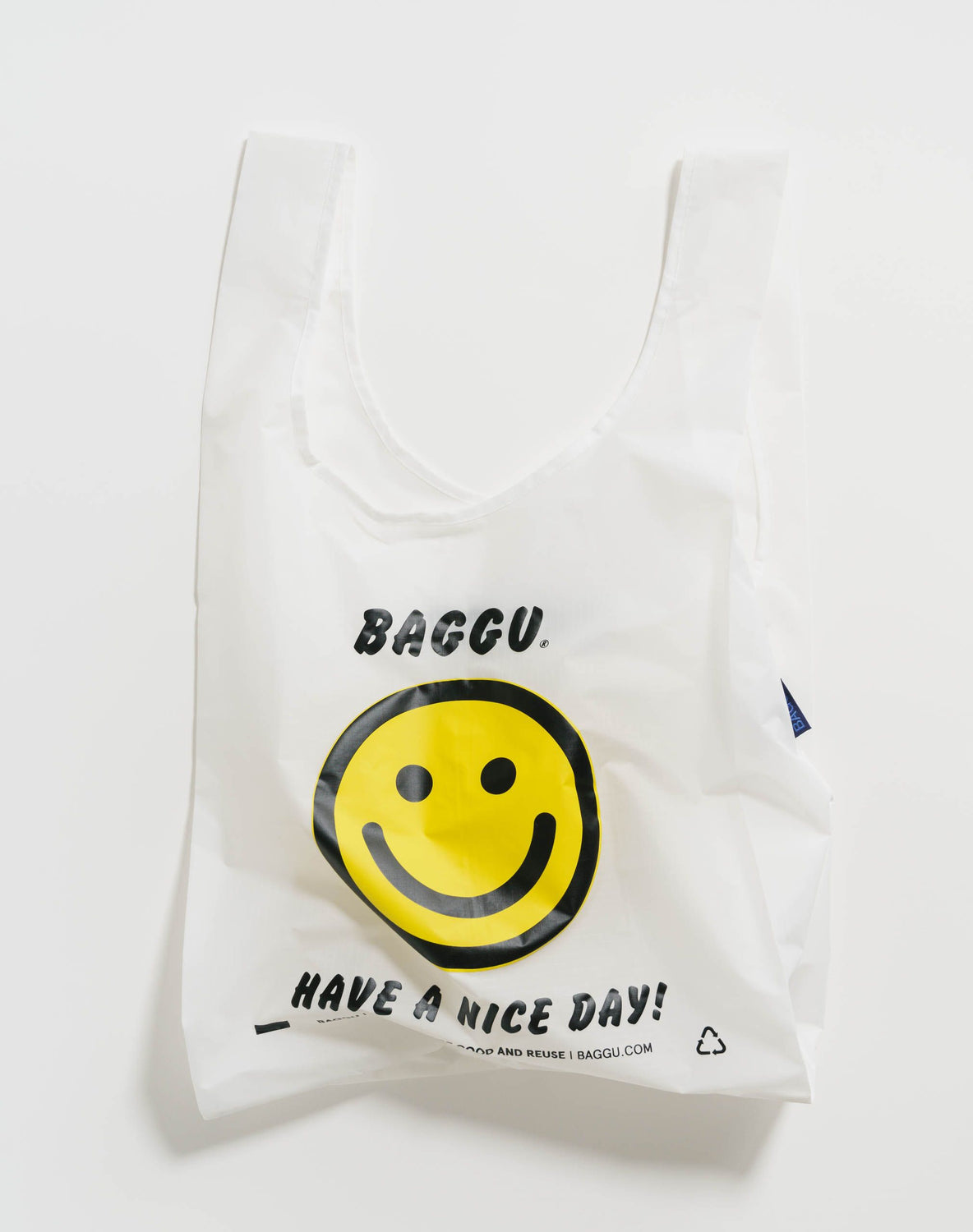 thoughtful gift ideas. White reusable shopping bag with smiley face reading have a nice day