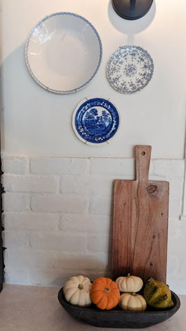 kitchen with white brick backsplash decorated with china plates