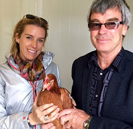 Sasha Conlan, Founder of Sasha's Fine Foods and Graeme Henergy, Owner of Henergy Cage-free Egg farm holding a hen.