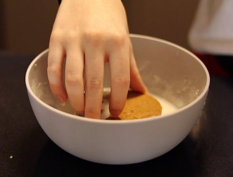 Dipping cookie in royal icing