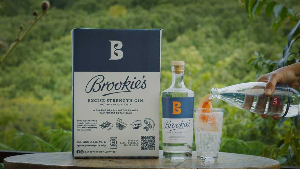 Pouring tonic water into a glass with Brookie's gin