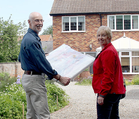 Happy customers leaving with the new art purchase for their home. © Neil McBride Art