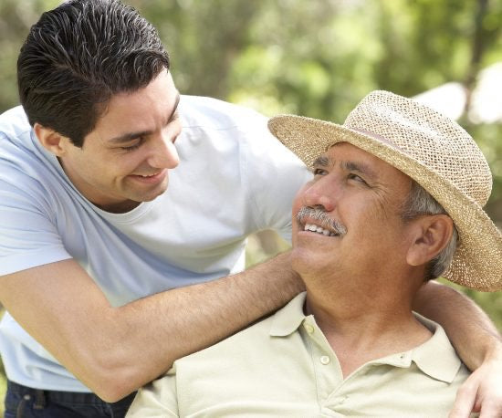 Close up shot of father and caring son smiling at each other