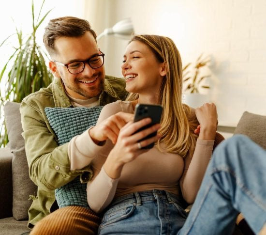 Married couple sitting on couch celebrating their 15th anniversary