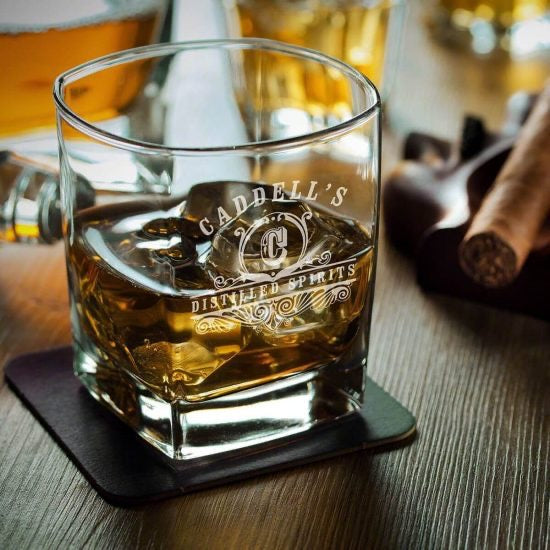 Classic rocks whiskey glass on table with ice inside