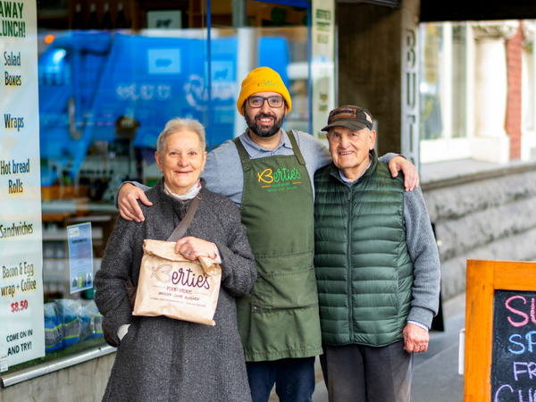Owner of Berties Butcher, Jason Gabriel standing with his mum and dad outside his butcher shop.