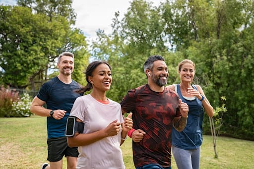 a group of people runing through wood