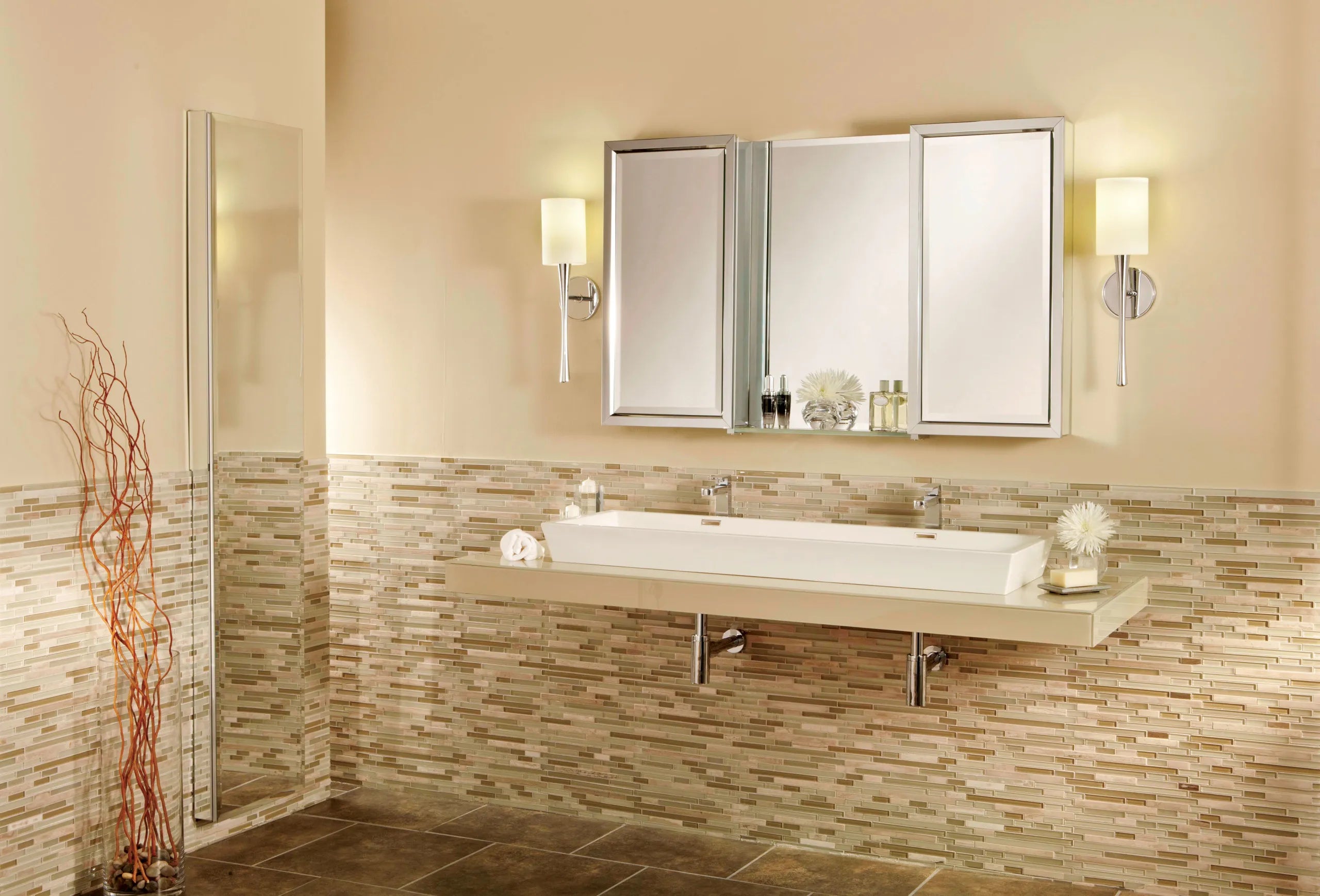 Modern bathroom with wall-mounted medicine cabinet mirror above a wide sink and mosaic tile backsplash.