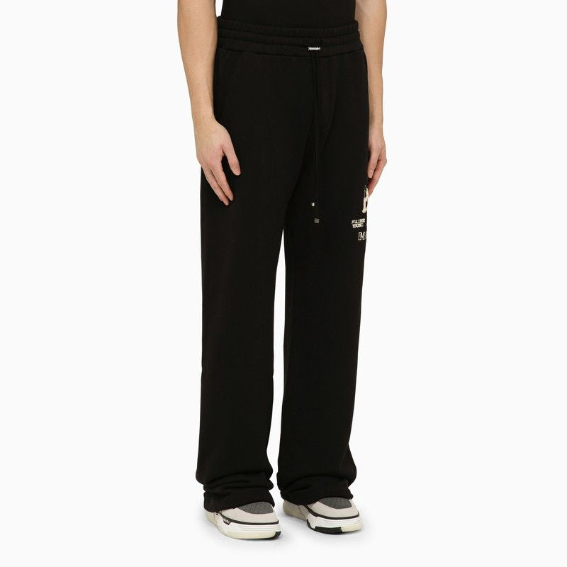 Shop Amiri Black Cotton Jogging Trousers For Men With Side Logo Print And Leather Label