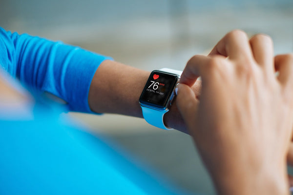 Woman using Apple Watch showing Heartrate