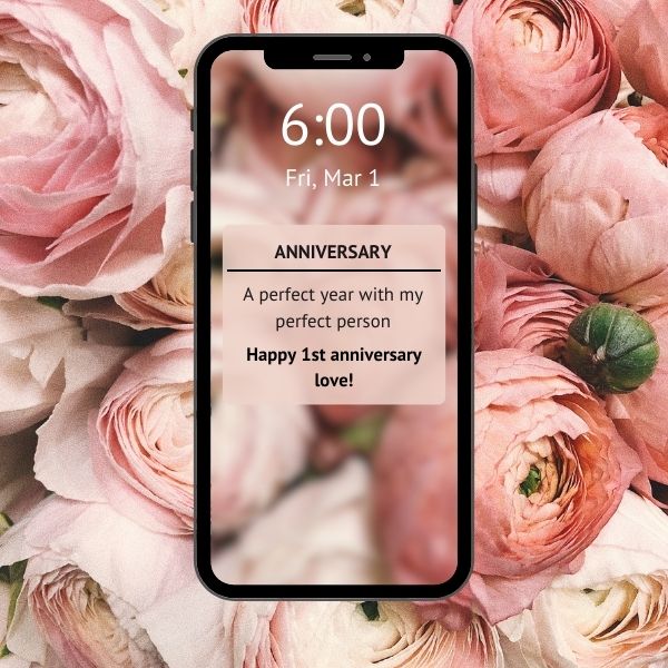 Phone notification displaying a sweet anniversary message, surrounded by romantic pink flowers, marking a special year.