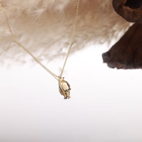 14k Solid Gold Penguin Necklace is an elegant and timeless piece.