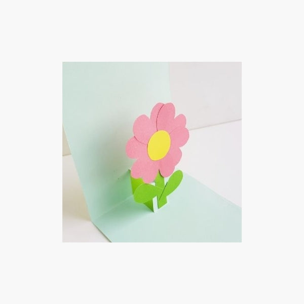 A vibrant 3-D flower popping out of a Mother's Day card.