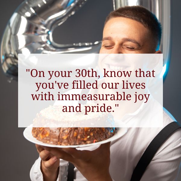 A man joyfully holding a cake with a message of pride for a 30th birthday.